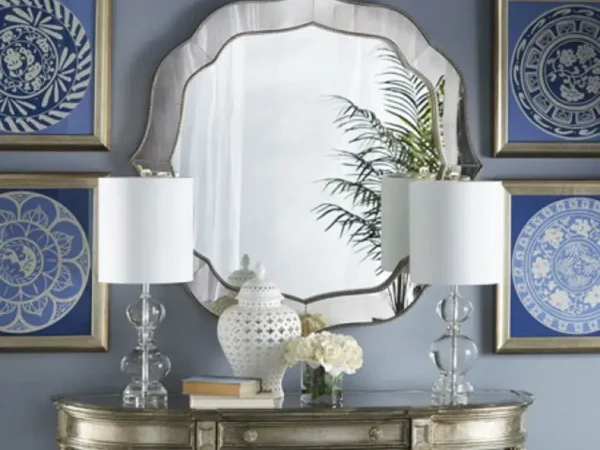 Elegant mirror with lamps and blue art pieces
