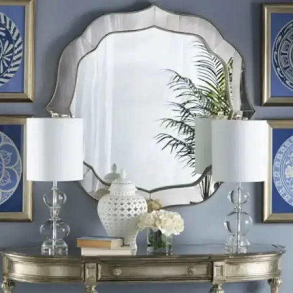 Elegant mirror with lamps and blue art pieces