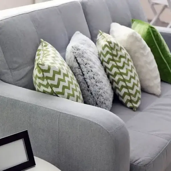 Gray sofa with green and white pillows