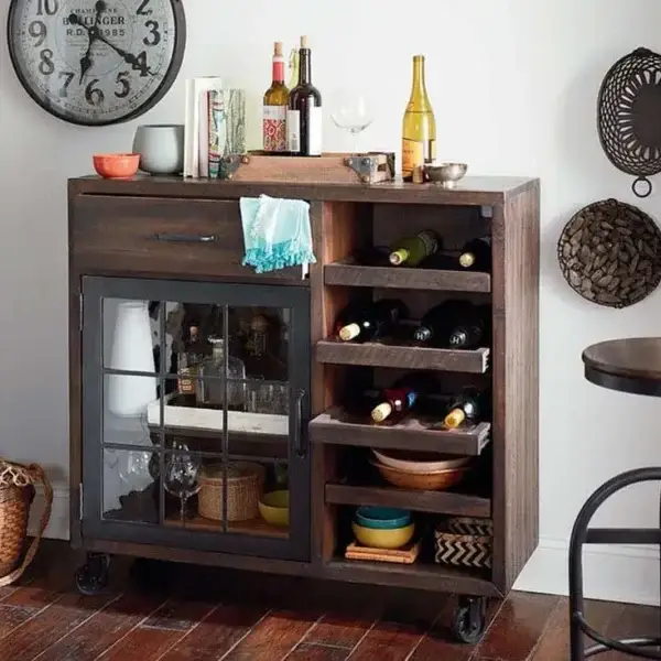 Wooden bar cabinet with wine and glassware.
