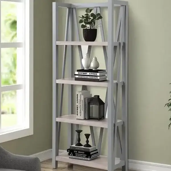 Modern gray bookshelf with decorative items by window.