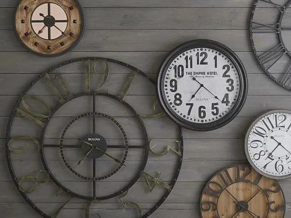 Wall with assorted vintage clocks displayed decoratively.
