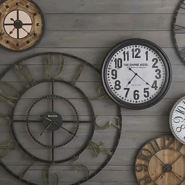 Wall with assorted vintage clocks displayed decoratively.