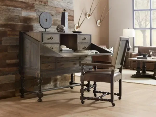 Rustic wooden desk with chair and decor items.