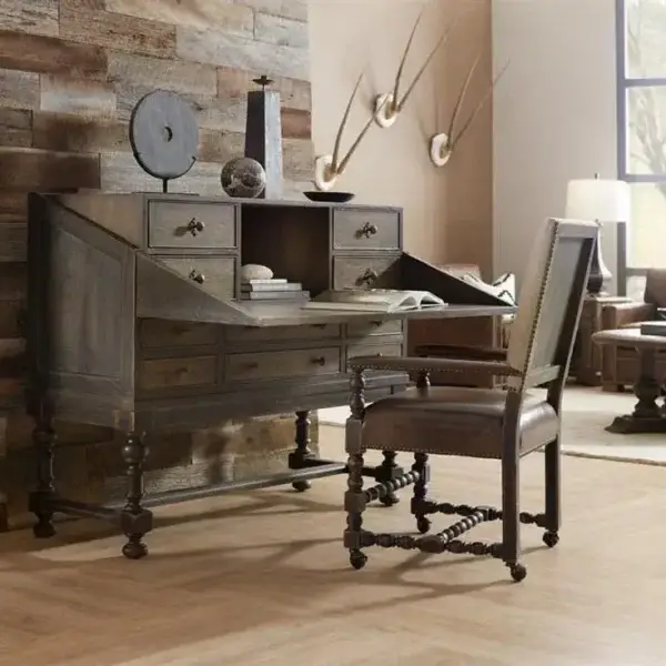 Rustic wooden desk with chair and decor items.
