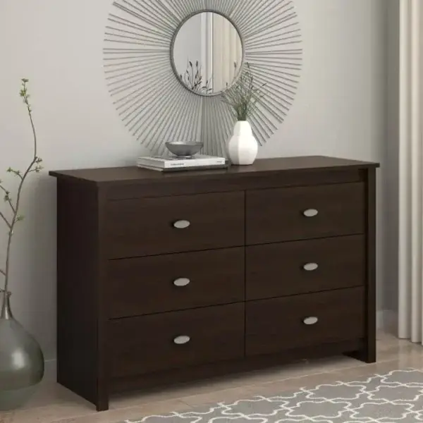 Modern dresser with decorative mirror in bedroom.