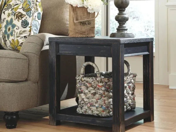 Rustic end table with flowers beside sofa.