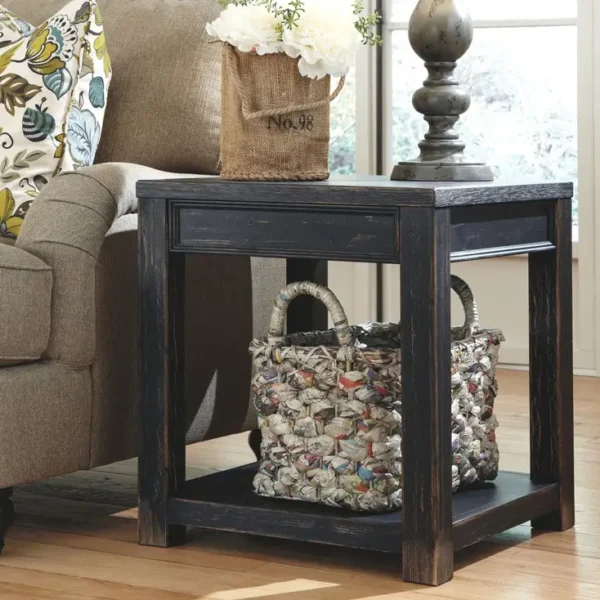 Rustic end table with flowers beside sofa.