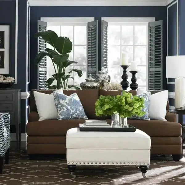 Stylish living room with blue walls and brown sofa.