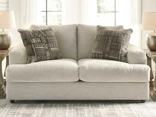 Cozy beige sofa with patterned cushions in living room.