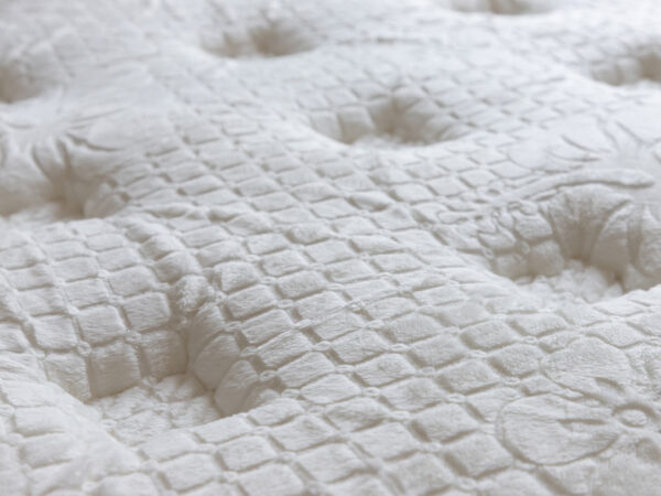 Close-up of textured white mattress surface