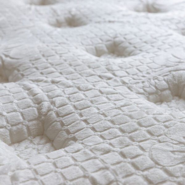 Close-up of textured white mattress surface