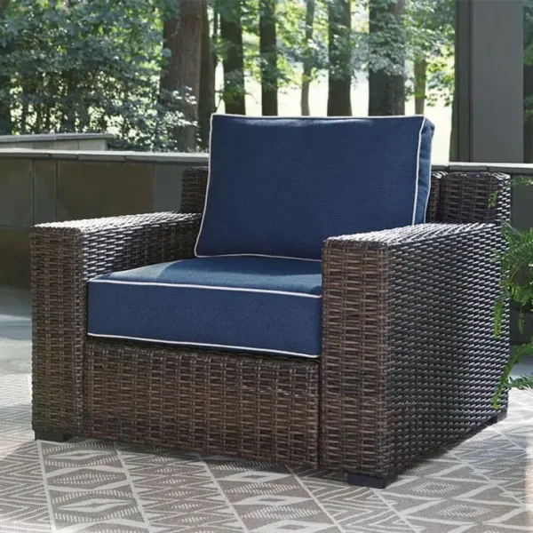 Wicker patio chair with blue cushions outdoors