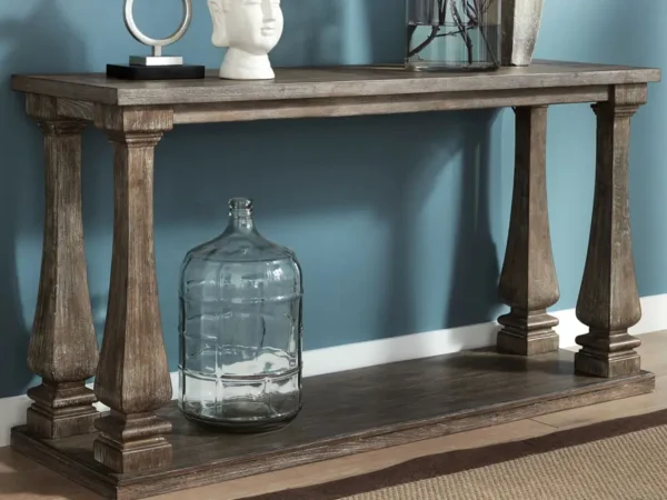 Wood console table with decorative objects and vase.