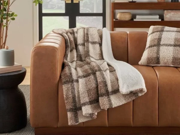 Cozy plaid throw on brown leather couch
