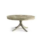 Round gray pedestal table with gold trim and integrated placemats.