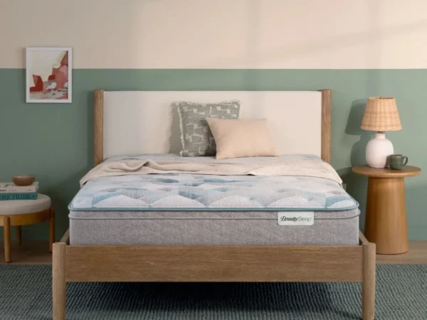 BeautySleep mattress on a wooden bed frame in a bedroom.