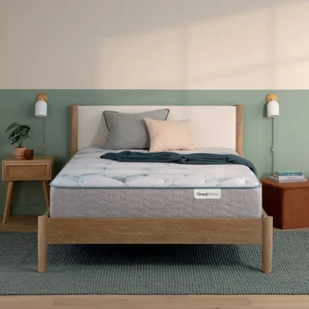 A BeautySleep mattress on a modern wooden bed frame.