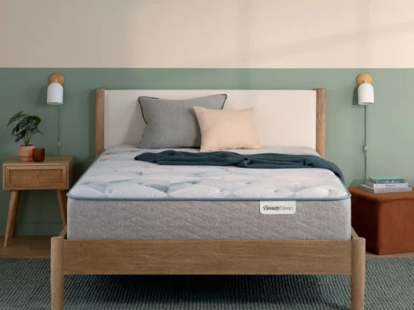 A BeautySleep mattress on a modern wooden bed frame.