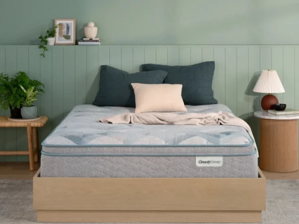 BeautySleep mattress on a wooden bed frame in a bedroom.