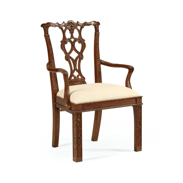 Ornate carved wooden Chippendale-style armchair with cream upholstered seat.