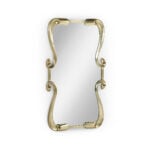 Modern gold wall mirror with elegant, curved frame accents.