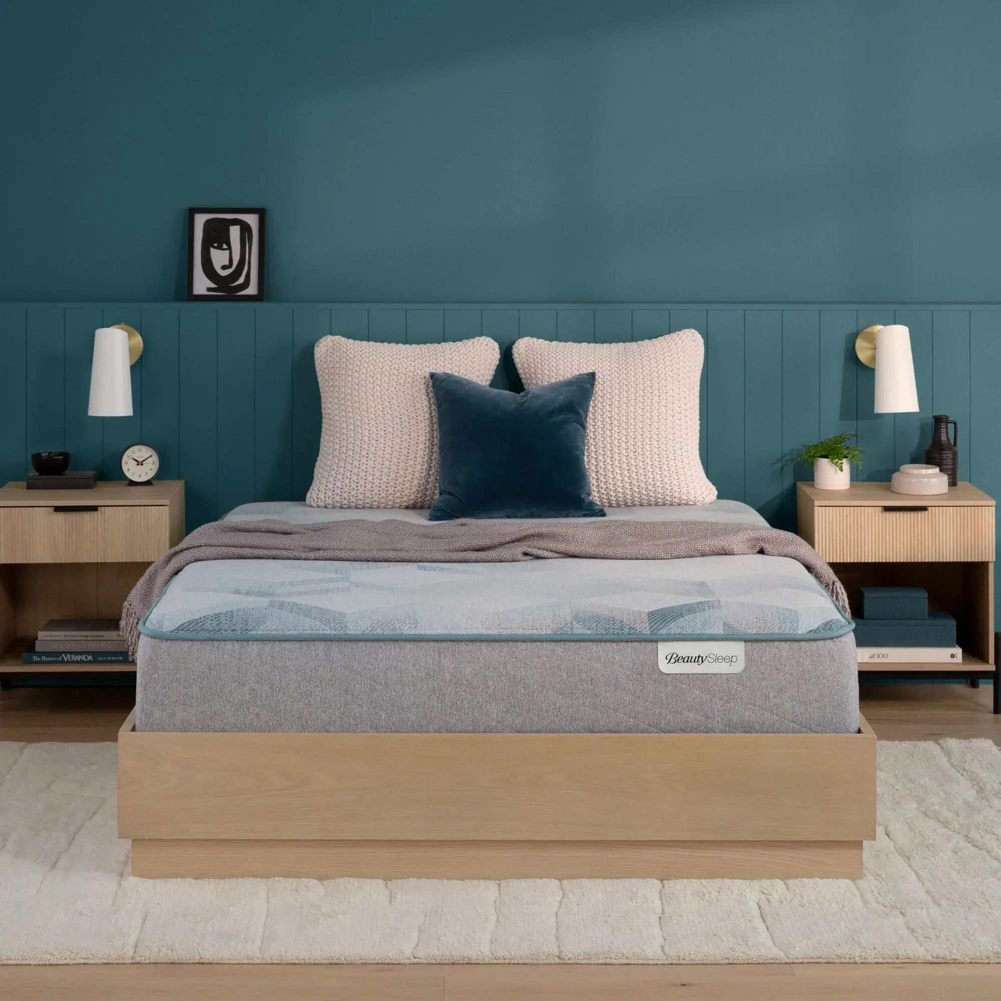 beautysleep dream weaver hybrid medium mattress 11.5" (copy) BeautySleep mattress on a wooden frame in a teal bedroom.