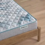 BeautySleep mattress with blue and white quilted pattern on wooden frame.