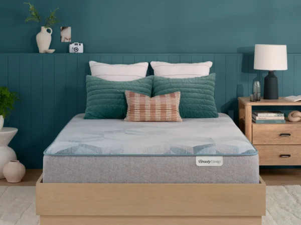 BeautySleep mattress on a wooden platform bed in a bedroom.