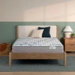 BeautySleep mattress on a modern wooden bed frame.