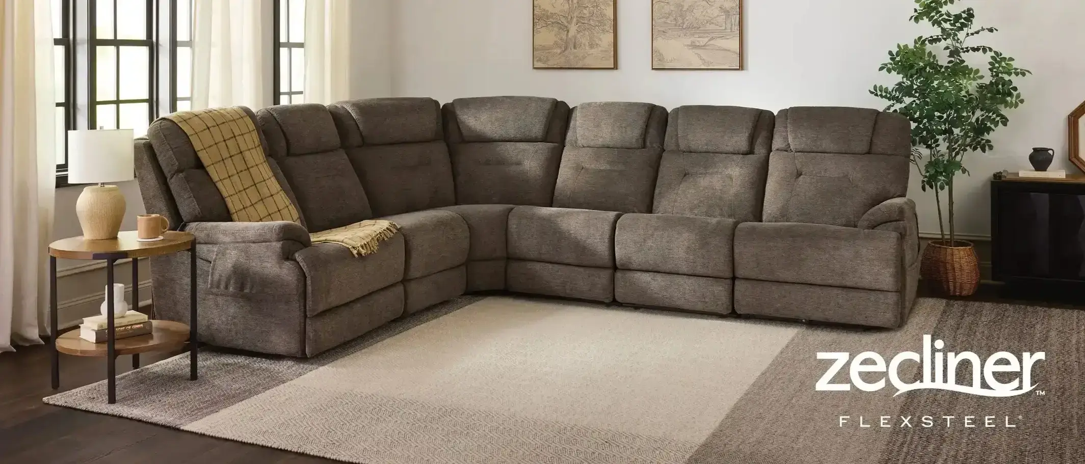 Grey L-shaped reclining sectional sofa in a modern living room.