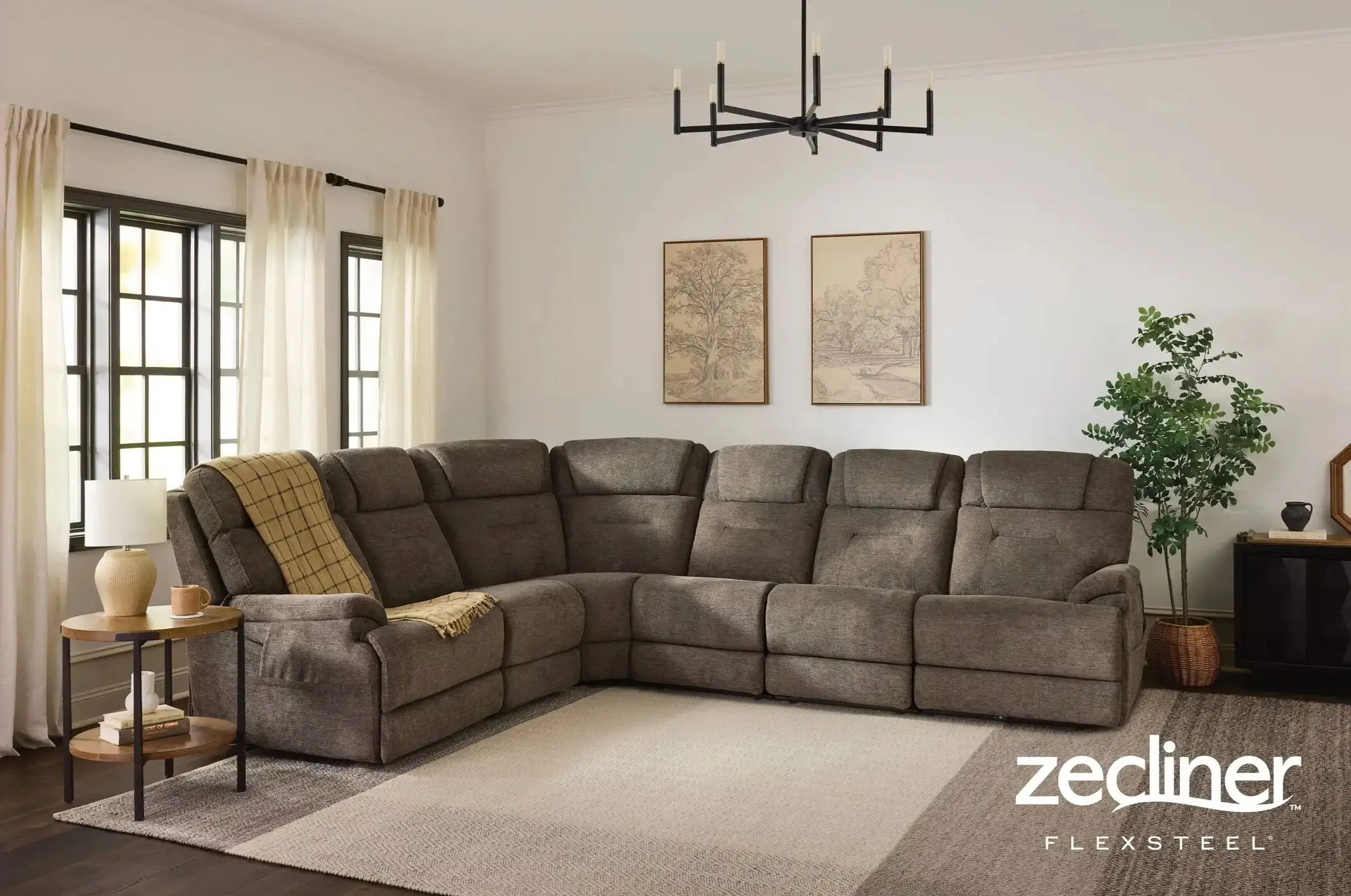 Large grey reclining sectional sofa in a modern living room.