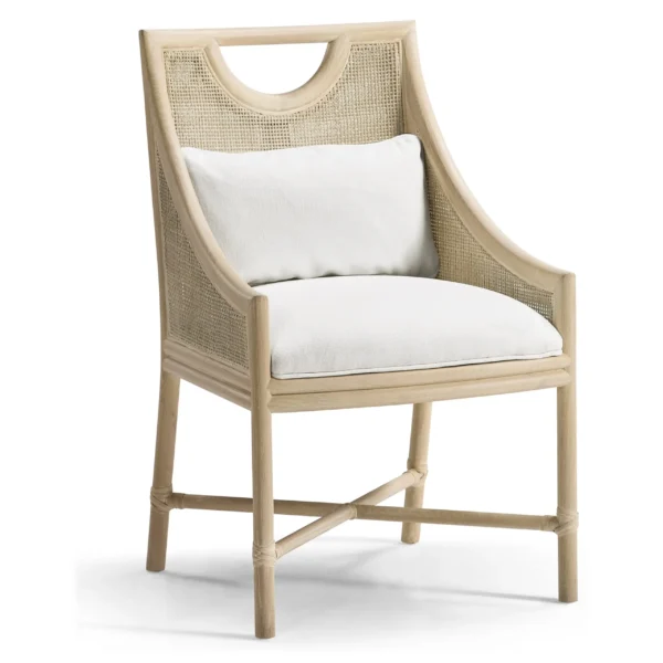 Light oak dining chair with cane back and white cushions.
