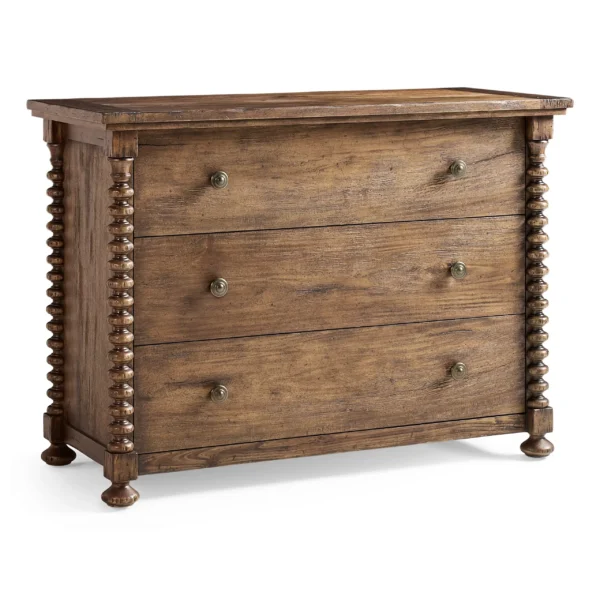 Rustic three-drawer wooden dresser with turned spool detailing.