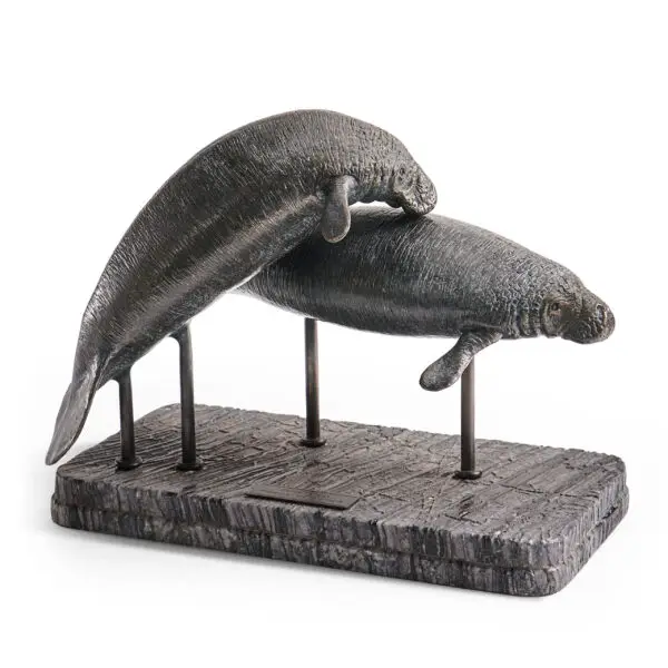 raised manatee bronze statue with marble base