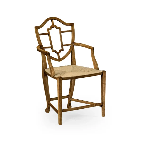 Antique wooden shield back armchair with woven rush seat.