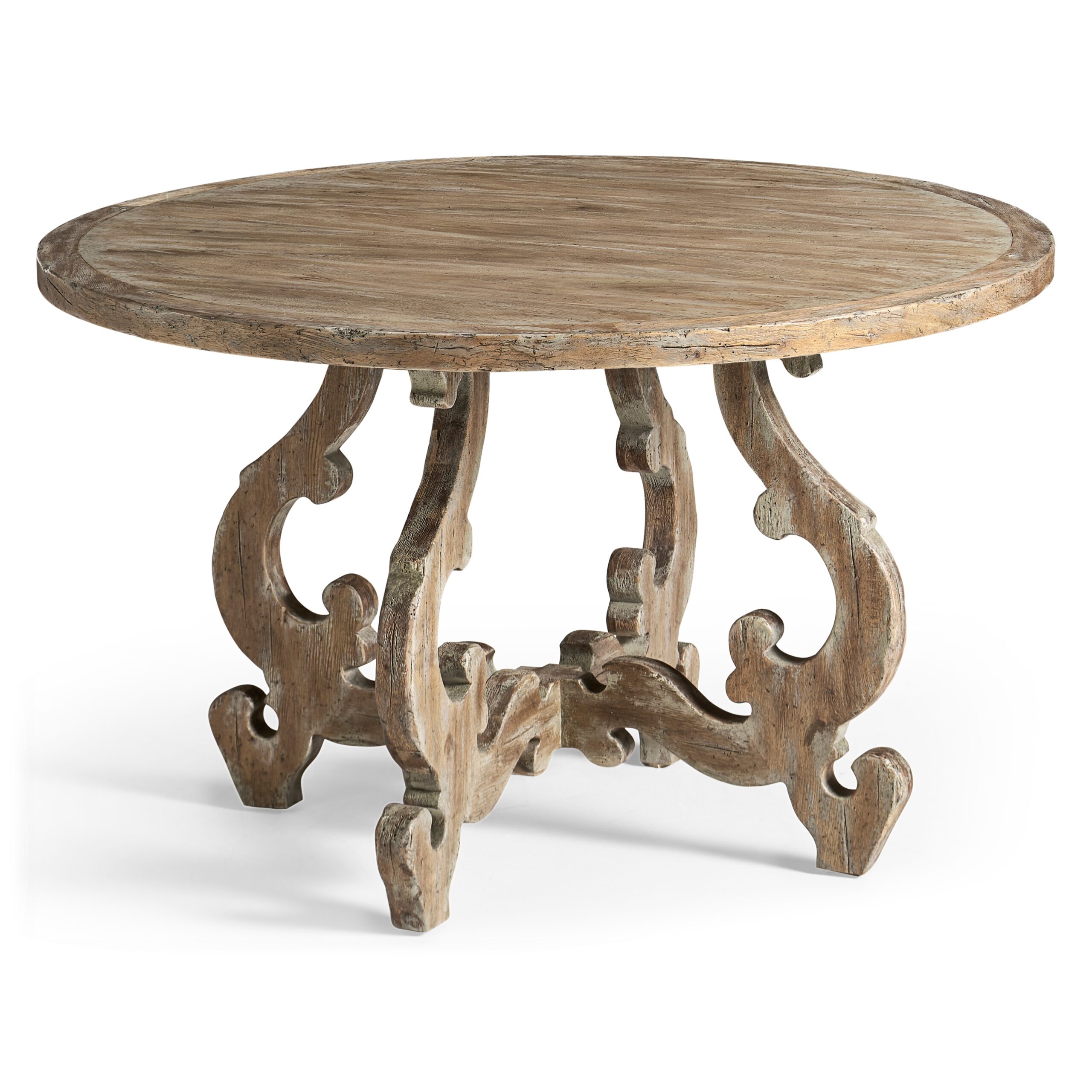 caldera round dining table Rustic round wooden table with ornate scrolled legs.