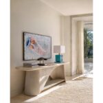 Modern console table with turquoise lamp and jellyfish artwork.