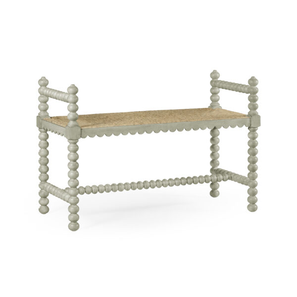 Light grey spindle bench with a woven seagrass seat.