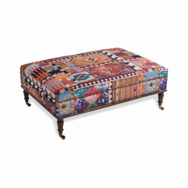 Vibrant kilim patchwork rectangular ottoman with brass casters.