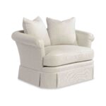 A beige rolled-arm accent chair with patterned throw pillows.