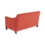 Rear view of a terracotta velvet loveseat with wood legs.