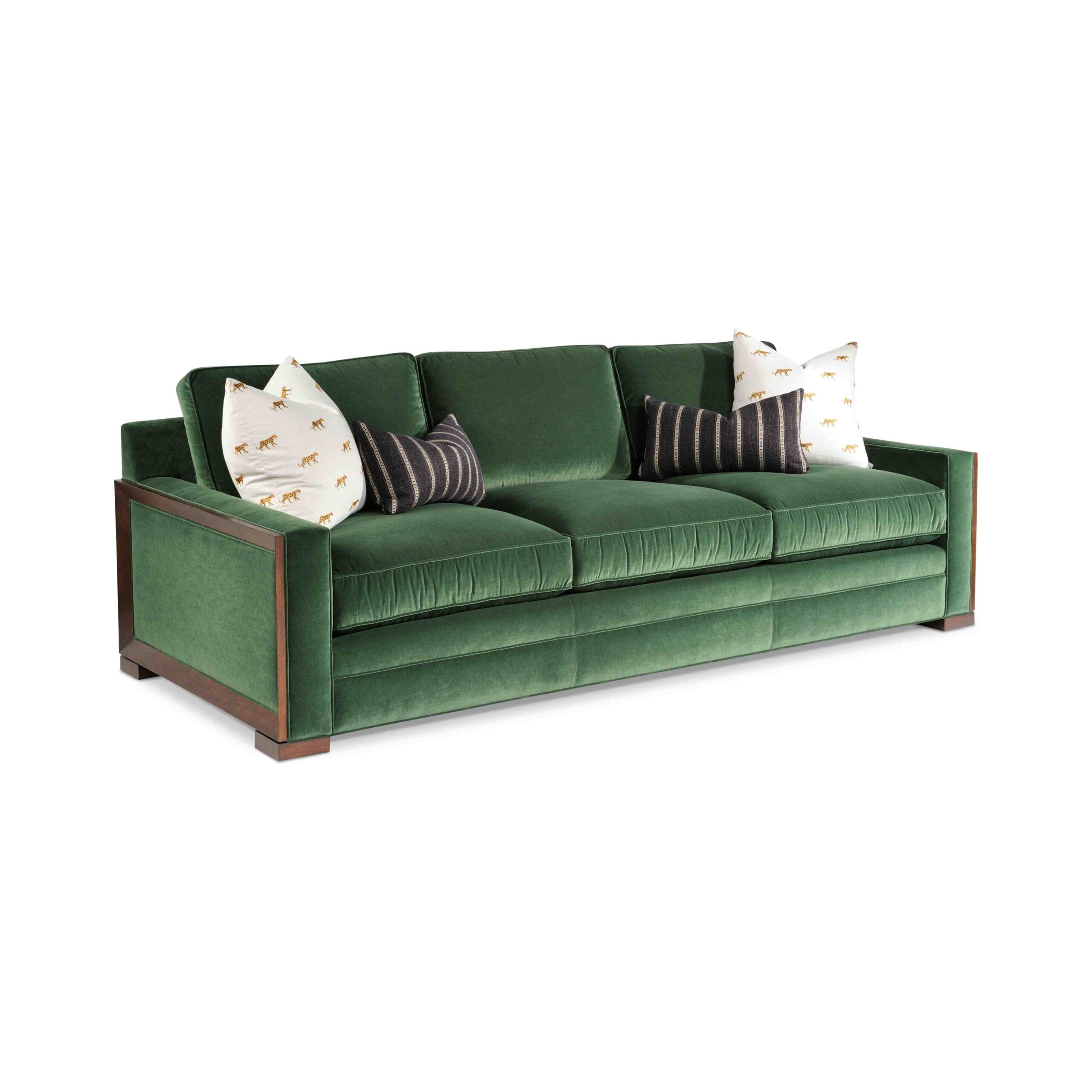 hopkins sofa w/ finished trim Green velvet sofa with white and striped pillows.