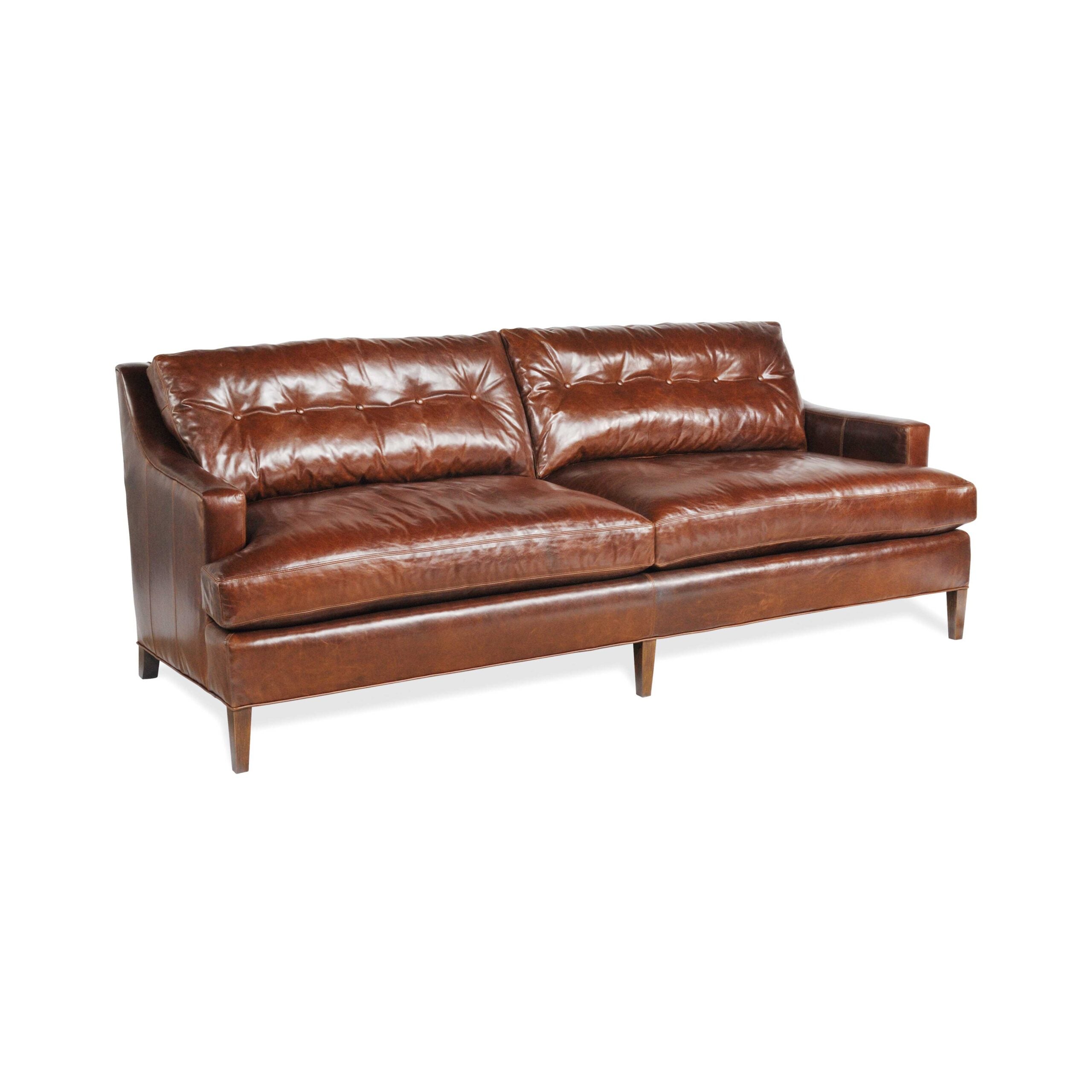 katz leather sofa Brown tufted leather sofa with tapered wooden legs.