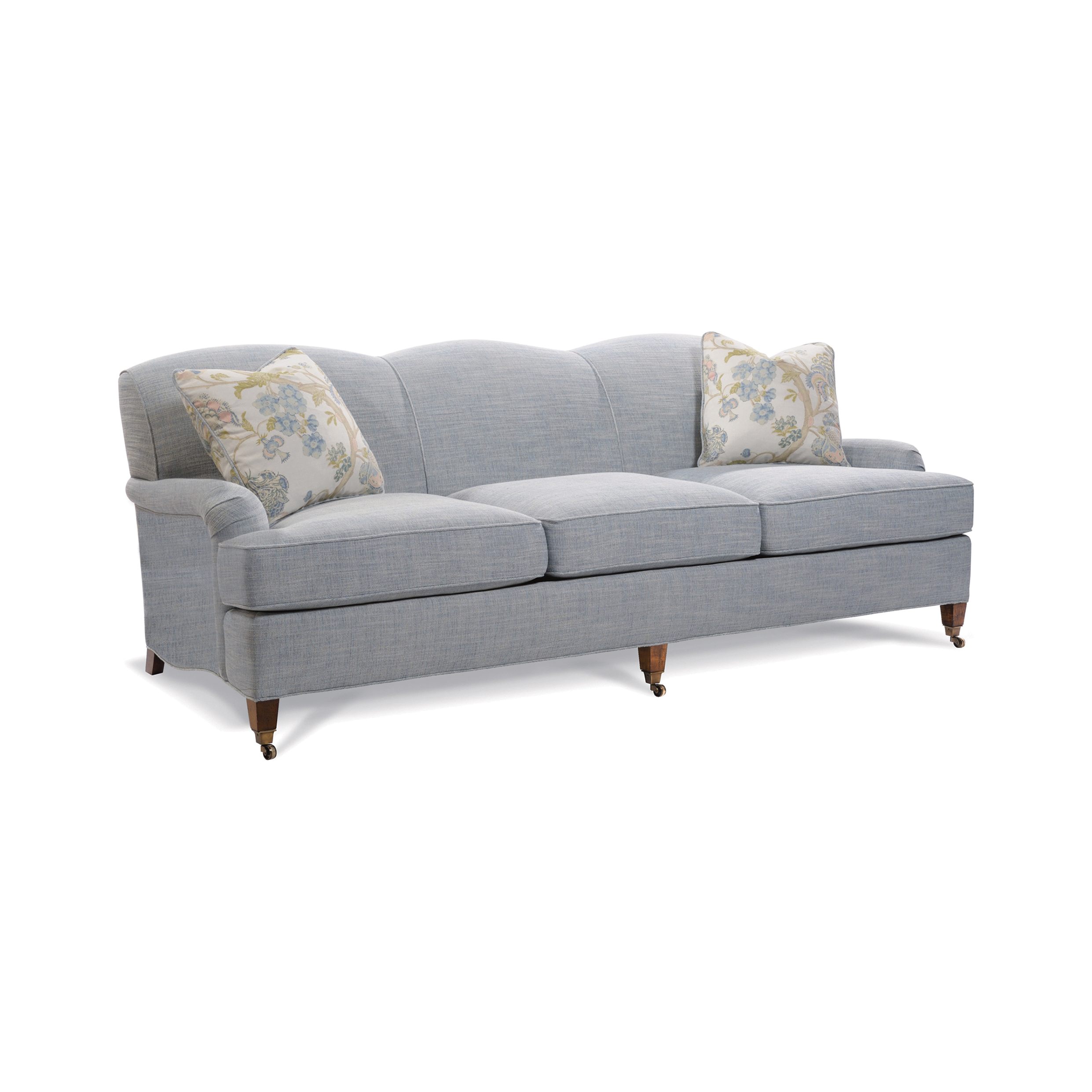 raleigh sofa Light blue scalloped-back sofa with floral accent pillows and casters.