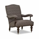 Traditional upholstered armchair with patterned fabric and wooden legs.