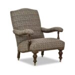 Traditional patterned armchair with turned wood legs and casters.