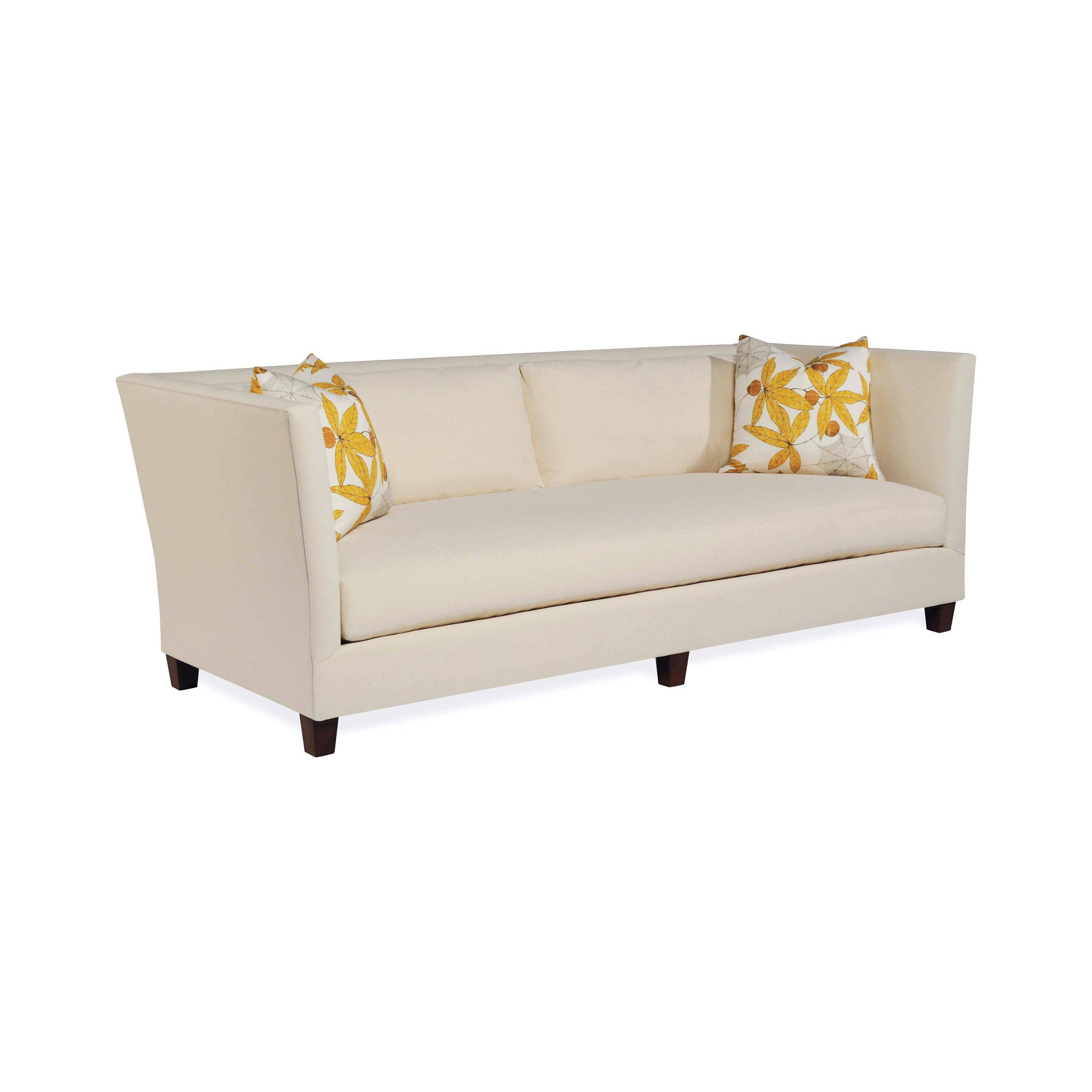 shelter sofa Cream tuxedo sofa with yellow floral patterned throw pillows.