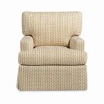 Tall back armchair featuring a patterned fabric and base skirt.