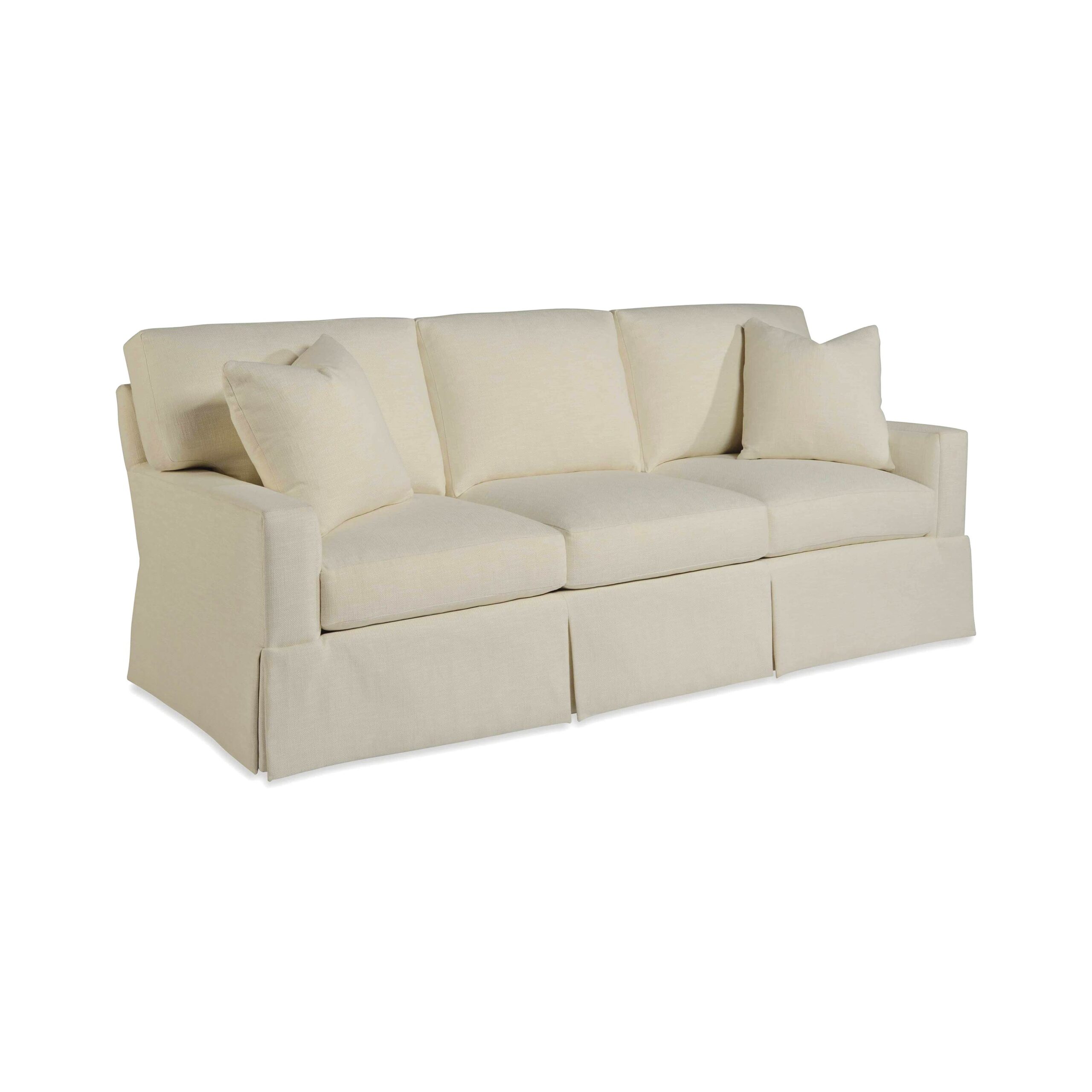 taylor made standard sofa Cream three-seat skirted sofa with two matching throw pillows.